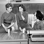 women gossiping office coffee break