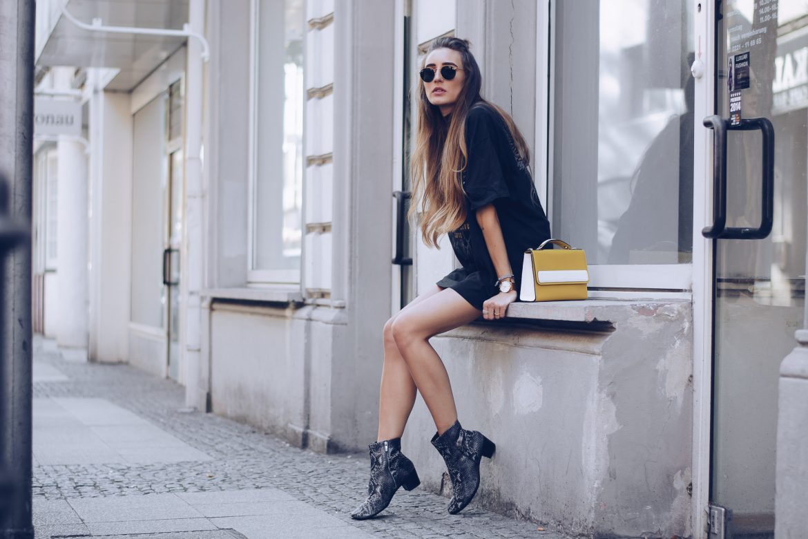 Stylish woman wearing black chelsea boots