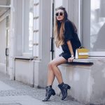 Stylish woman wearing black chelsea boots
