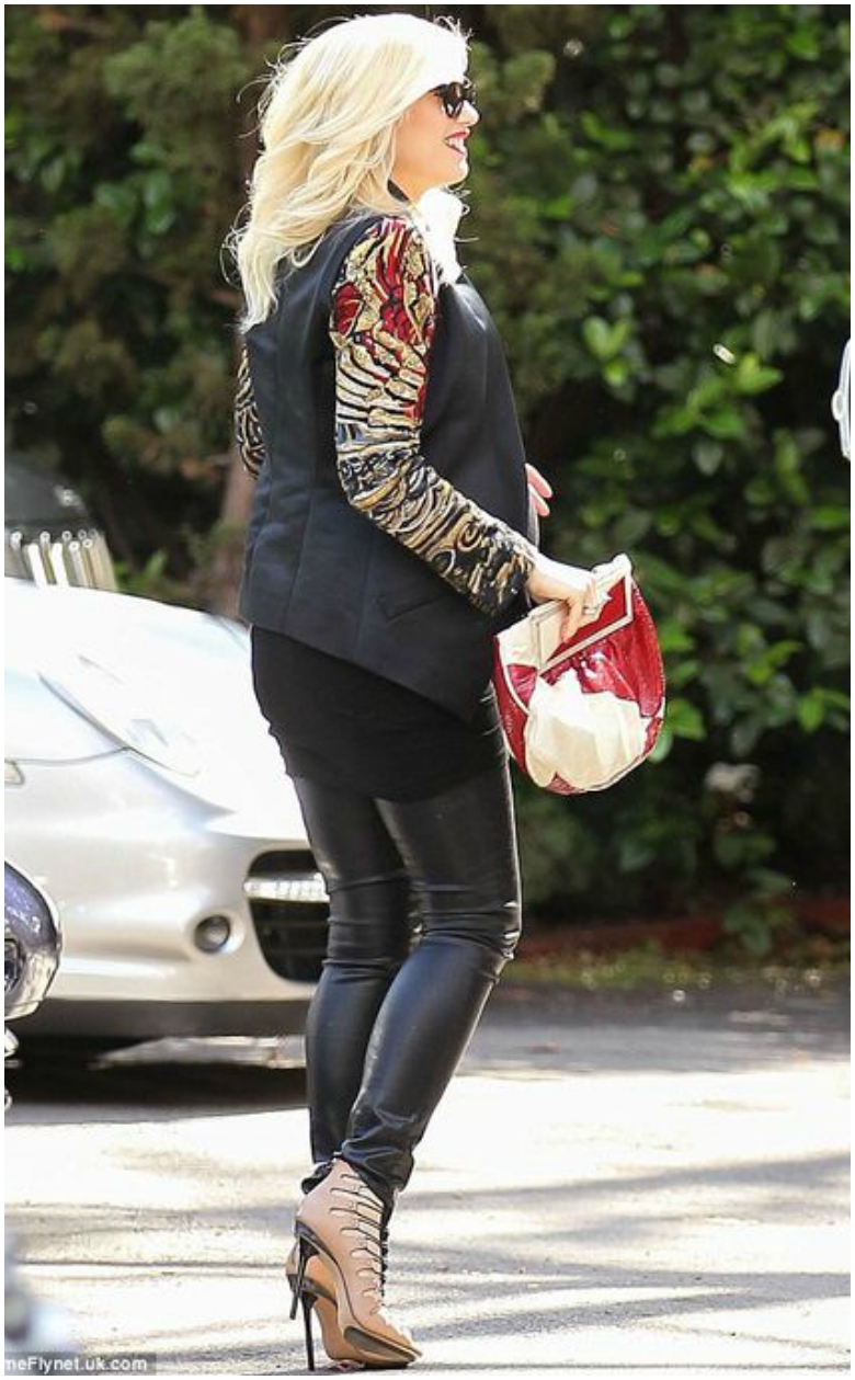Pregnant Gwen Stefani in leather trousers and black blazer with colourful sleeve detail