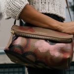 Woman carrying leather Burberry handbag