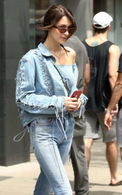 Bella Hadid street style blue jeans, blue denim jacket and blue crop top with trainers - shop the look