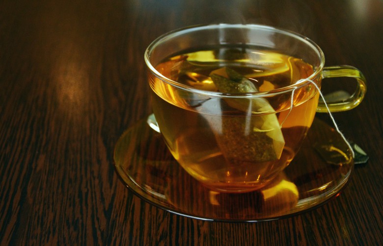 Top 5 ways to increase metabolism, green tea - a cup of tea on wooden table 
