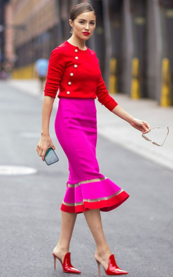 Olivia Culpo in red and pink pencil skirt and a red sweater