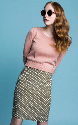 Model in pink top and polka dot pencil skirt