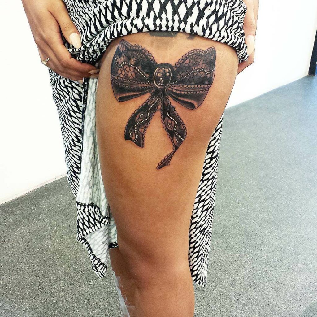Awesome Black Ink Corset With Bow Tattoo On Girl Both Back Leg