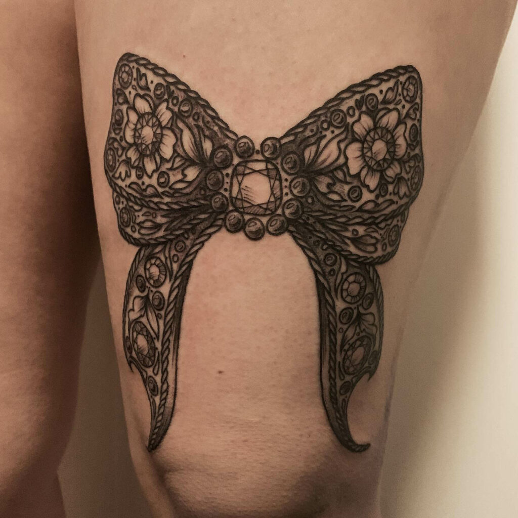 Bejeweled Bow Tattoo On The Thigh