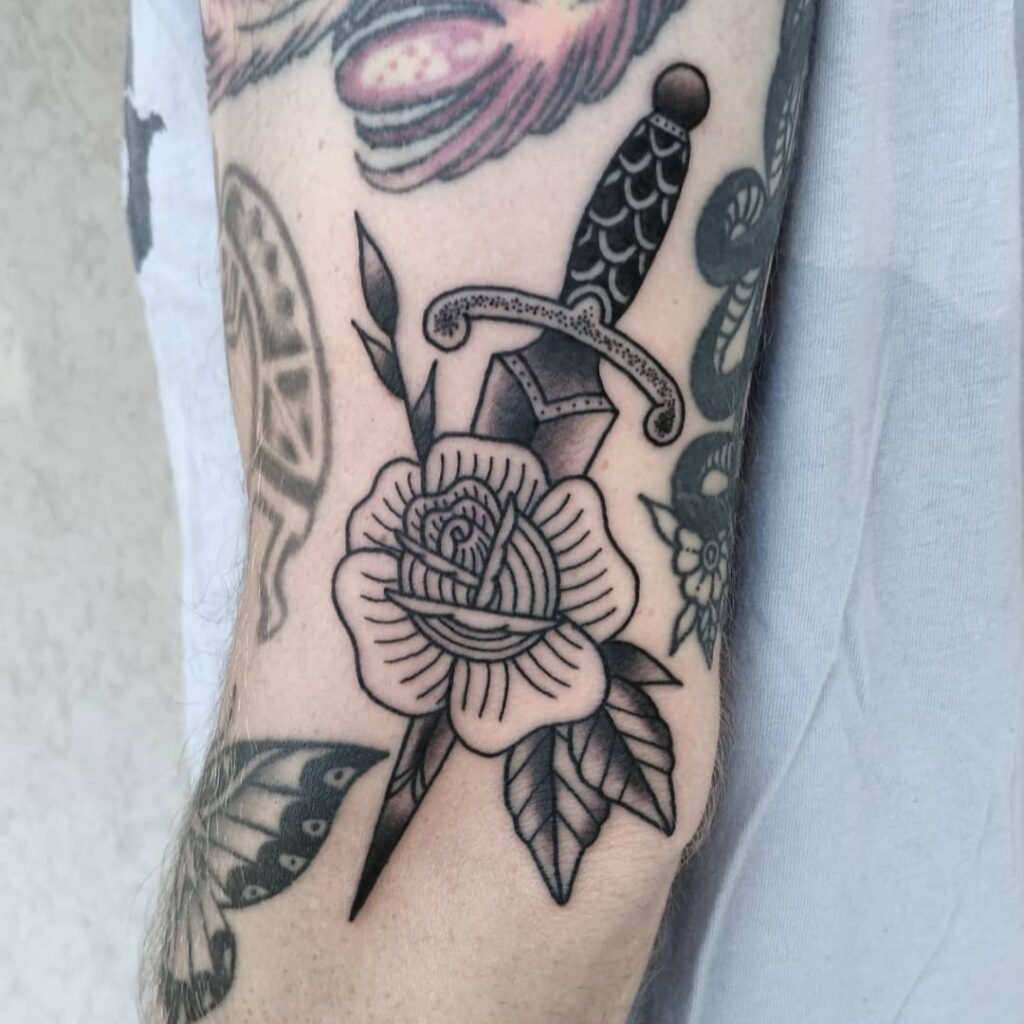 Another Beautiful Black Dagger Tattoo Going Through A Rose