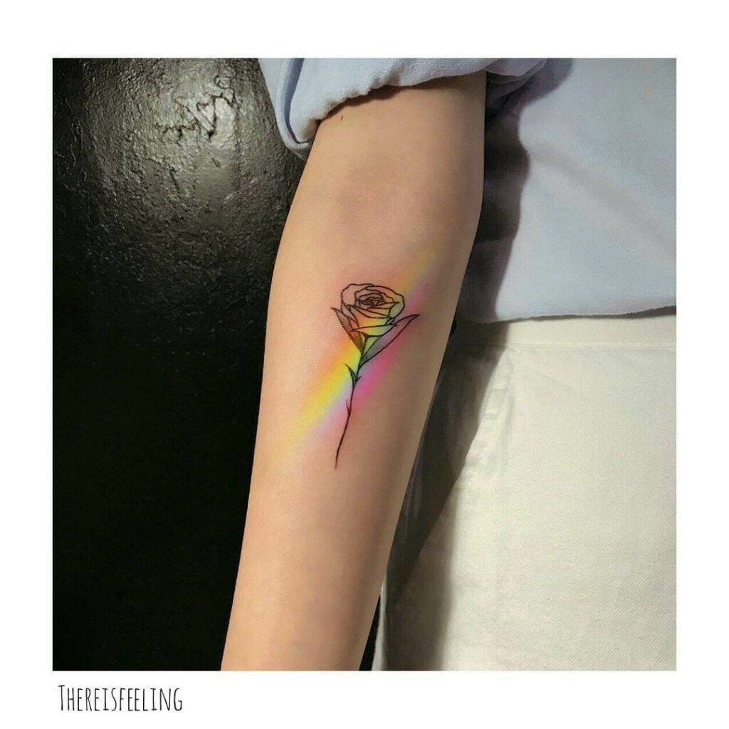 Tiny minimalistic unicorn and rainbow tattoo located