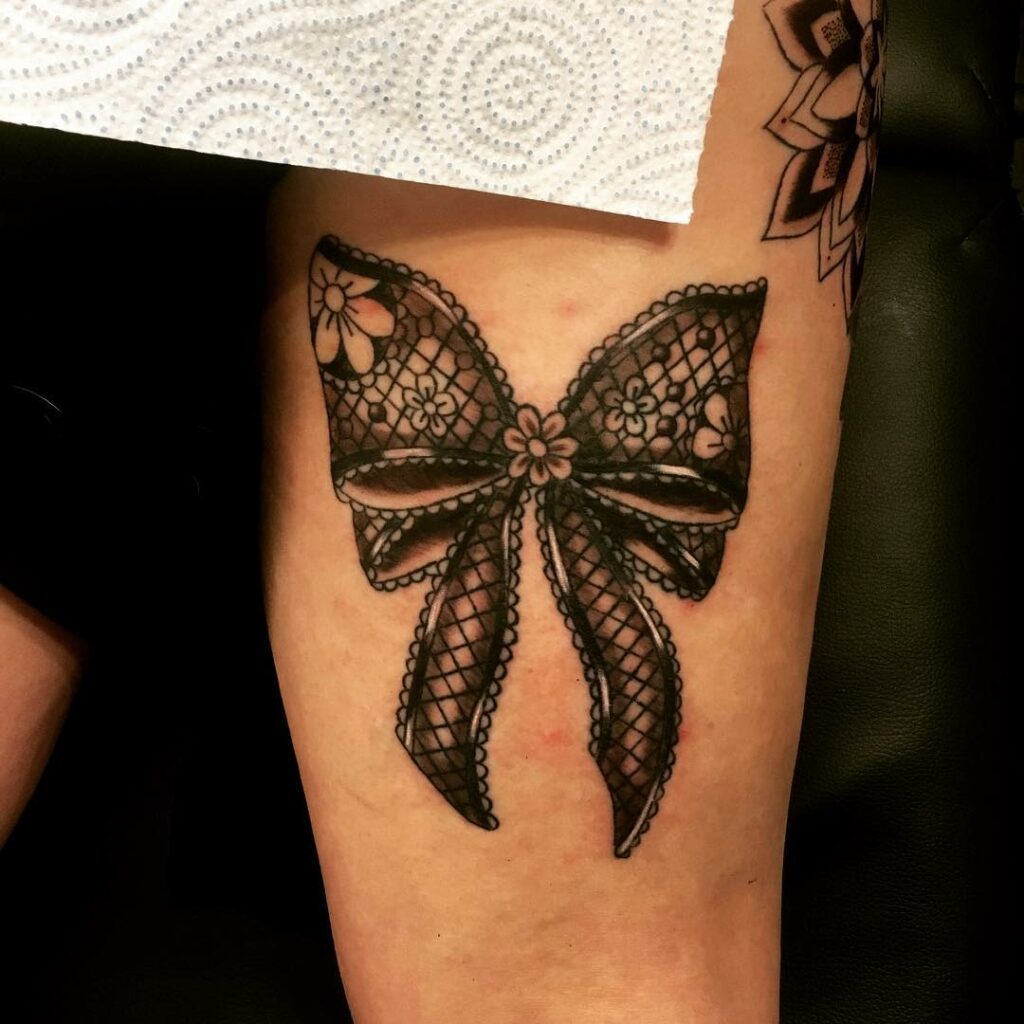 Bow On Back Of Thigh With Flower Tattoo Designs