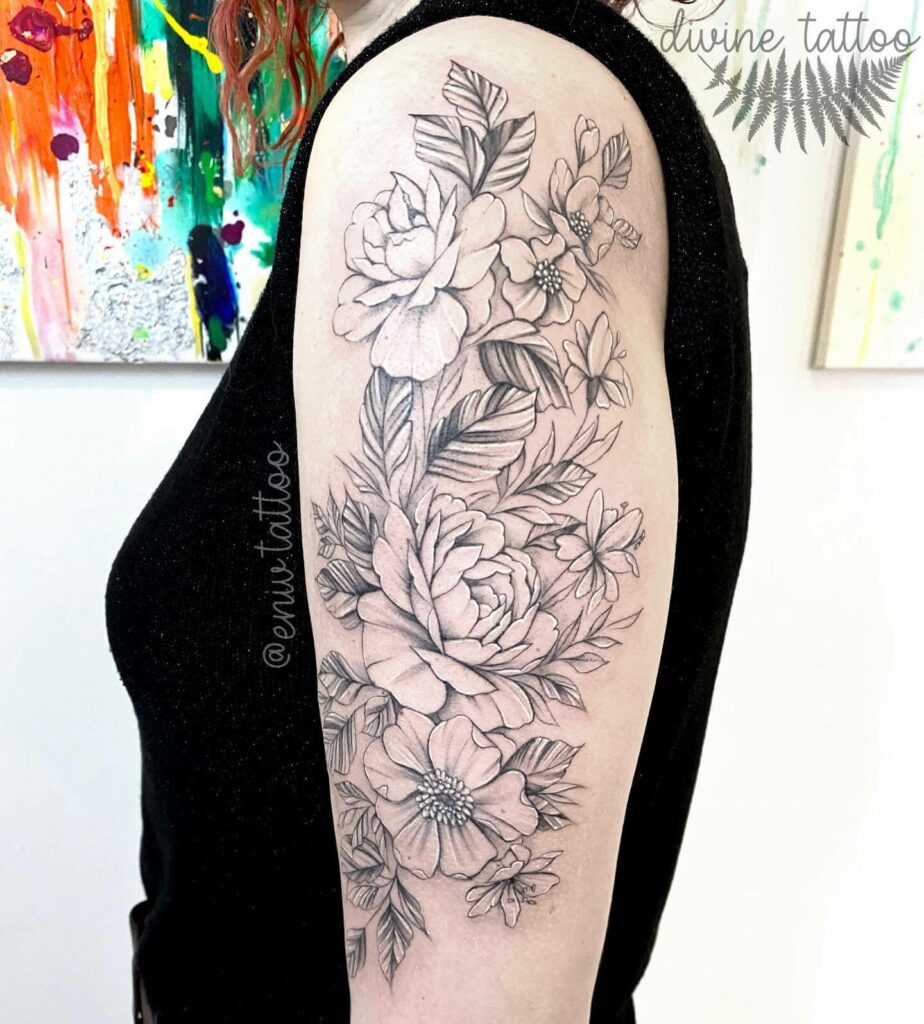 Beautiful Small And Big Flower Tattoo On Arm In Black