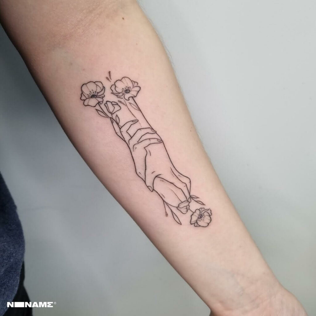 Minimalist flower-art hand tattoo