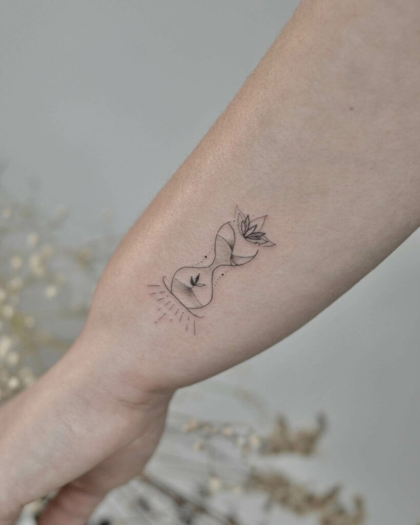 The Small Girly Hourglass Tattoo With Flowers