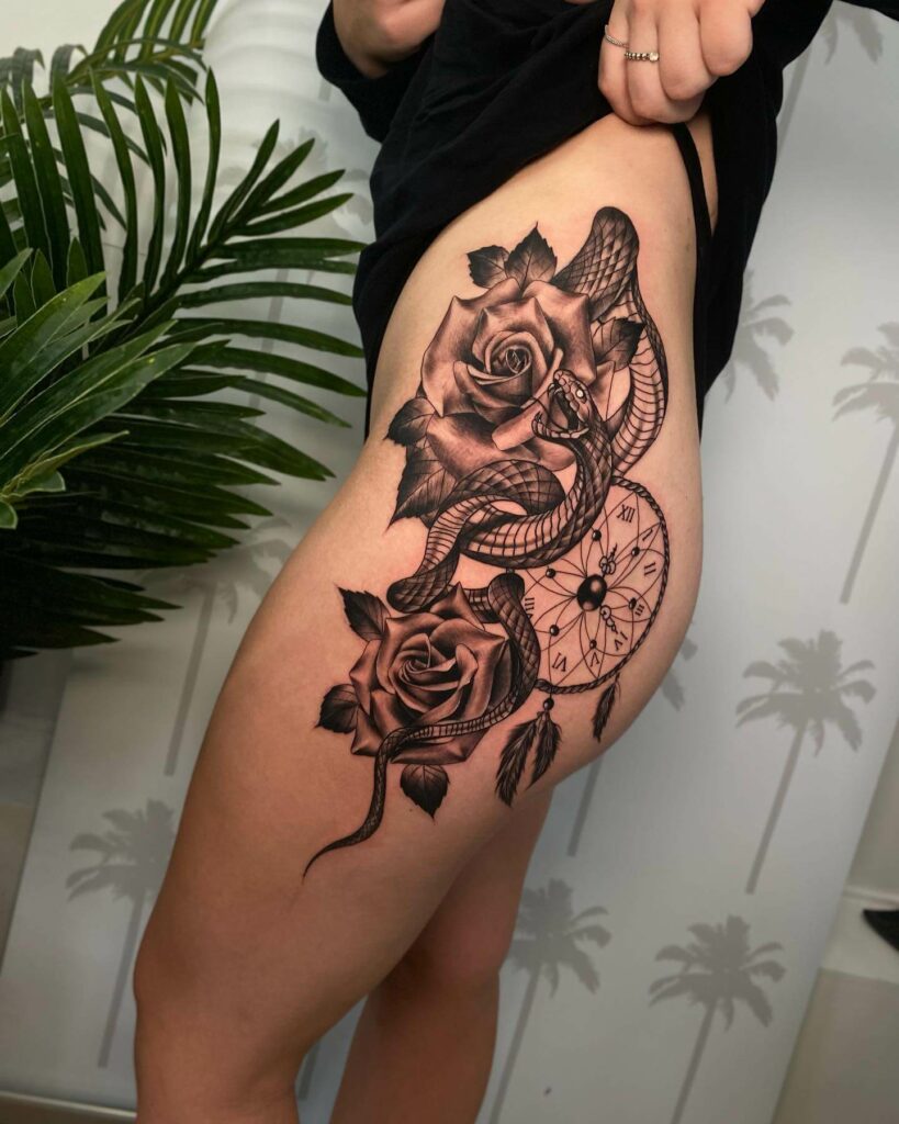 Fine line rose tattoo on the hip