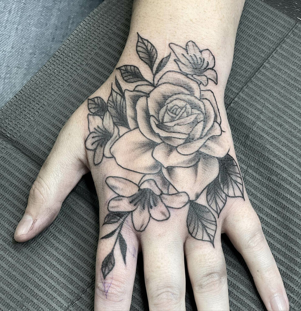 Poppy Rose hand tattoo by Jonathan Montalvo TattooNOW