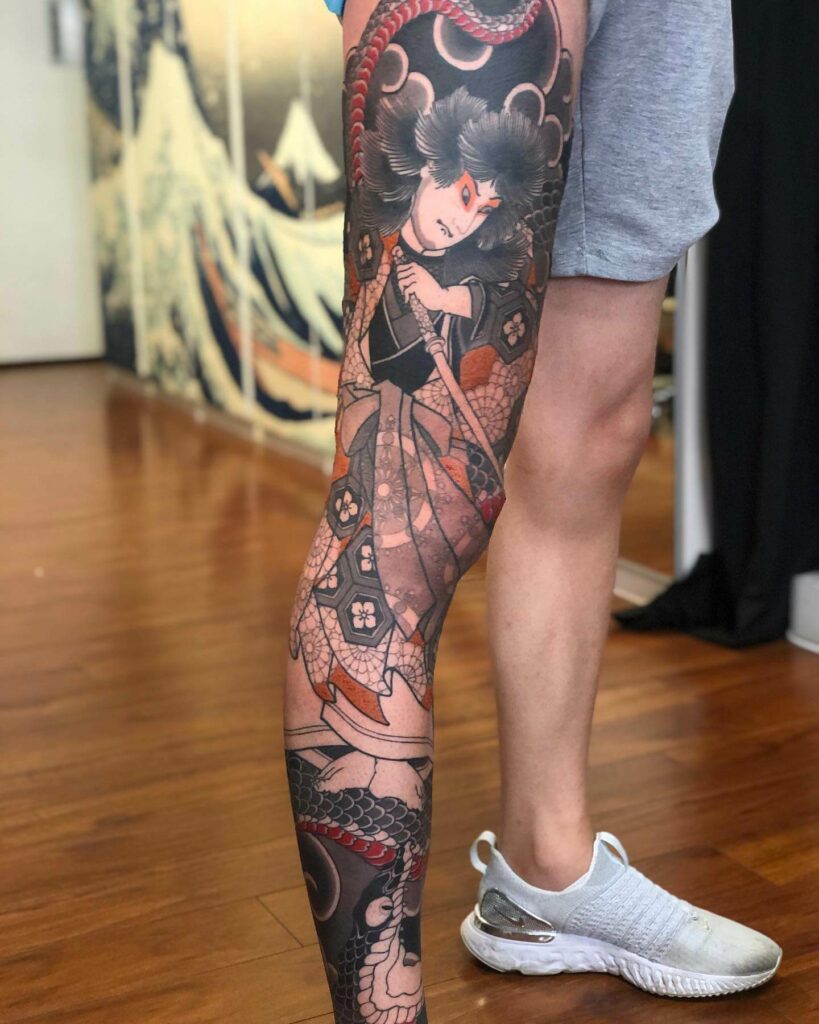 koi and chrysanthemum leg half sleeve tattoo by Dana Helmuth TattooNOW