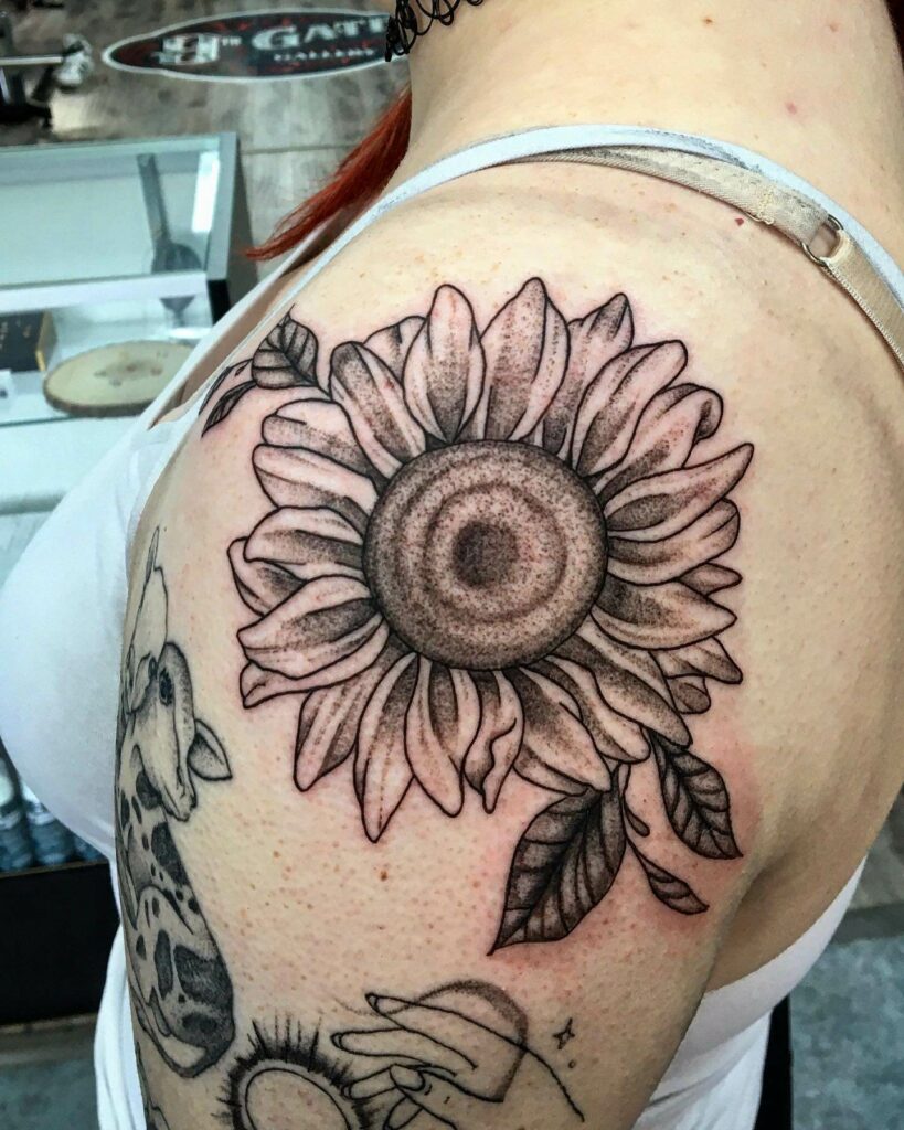 Classic sunflower shoulder tattoo with leaves