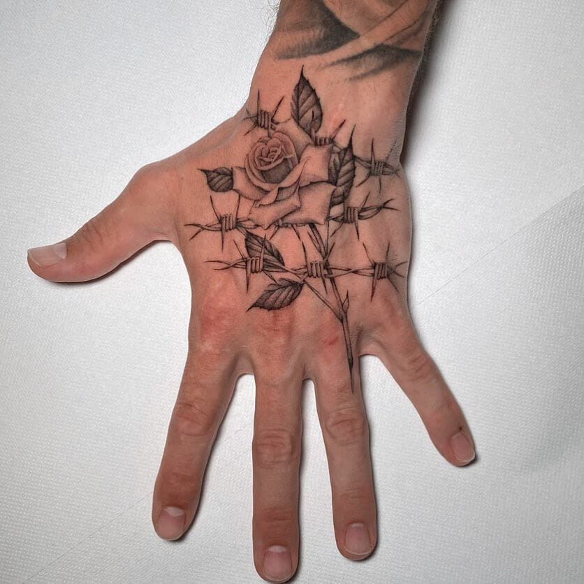Rose With Thorns X Barbed Wire Hand Tattoo