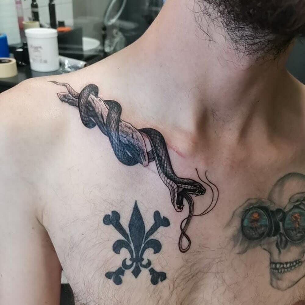 Tattoo uploaded by Spoken Hand Tattoo  Snake collarbone  Tattoodo