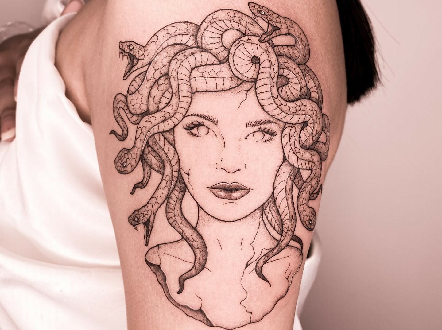 Illustrative style Medusa tattoo on the right upper arm