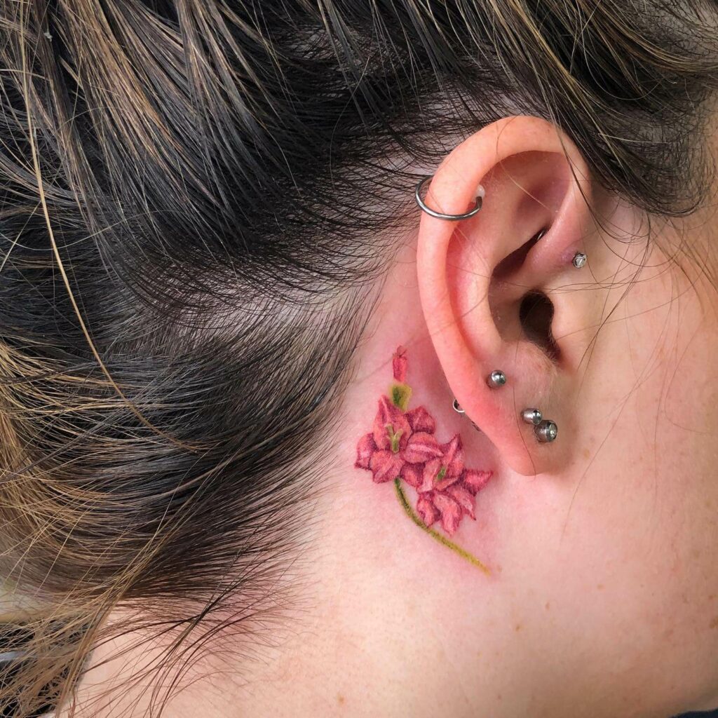 Pink Gladiolus Flower Tattoo Design At The Back Of The Ear
