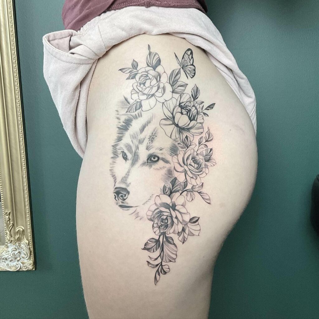 Rose, Wolf, And Butterfly Hip Tattoo