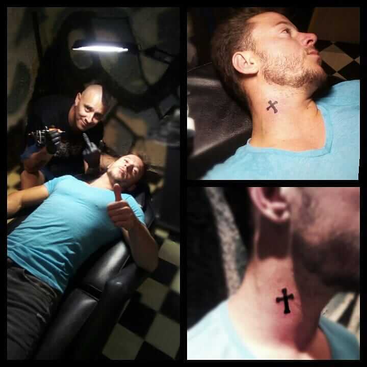 Small Cross Tattoo On The Side Of The Neck