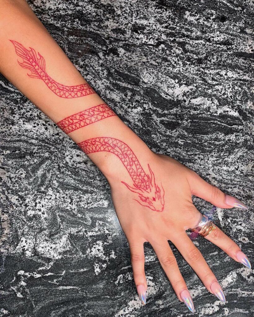 Right Wrist Spiral Red Dragon Nikita Dragun Hand Tattoo
