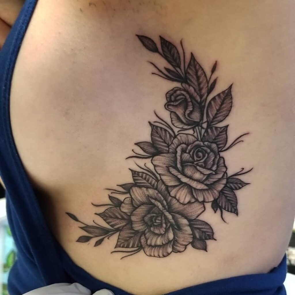 Microrealistic pink rose tattoo on the side boob