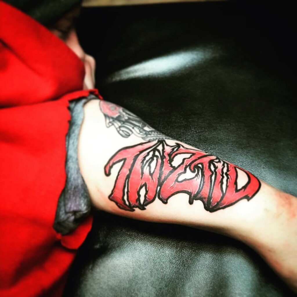Funky Lettering Hand Tattoo