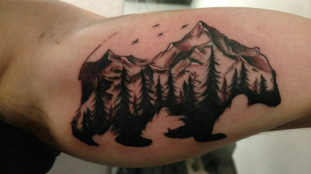 Showcase your adventurous spirit with a mountain range tattoo