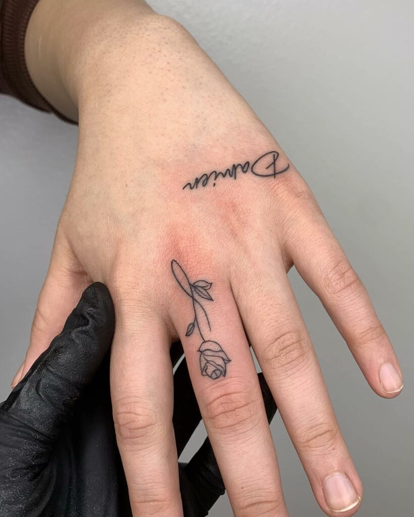 Beautiful Black Name Hand Tattoo With Rose