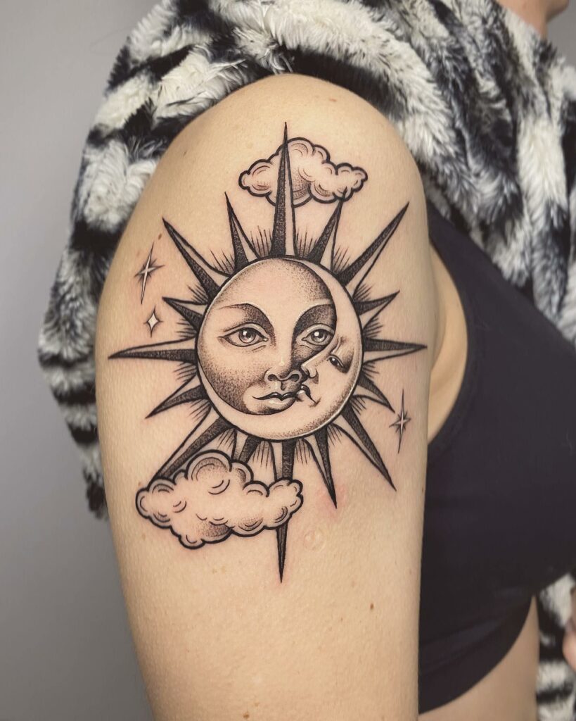 Sun and cloud tattoos on the left side of the chest