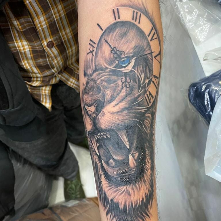 Big Lion Tattoo With Clock On Forearm
