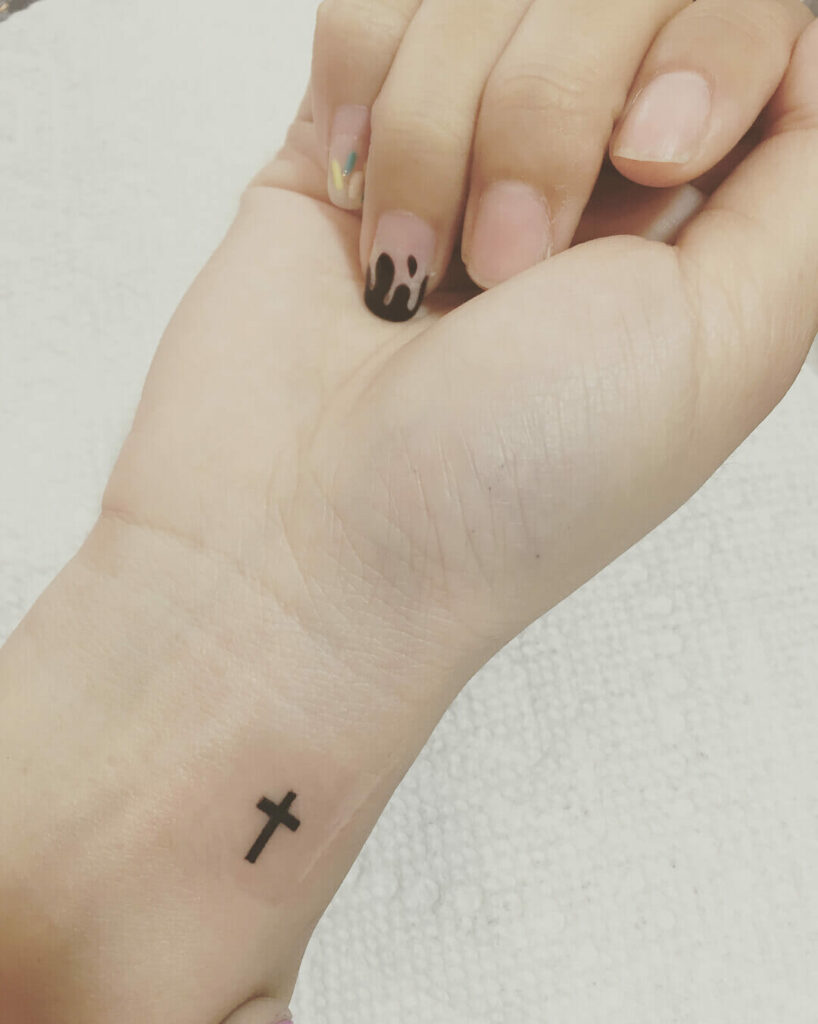 Black Cross Wrist Tattoo