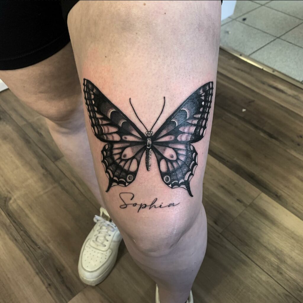 Butterfly thigh tattoo with name:
