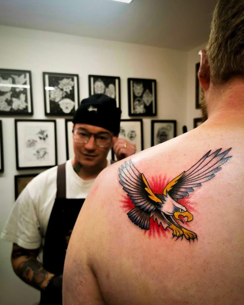 Colourful Eagle In Action Tattoo