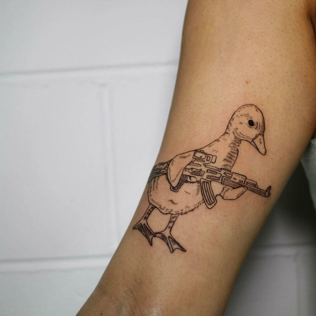 Common Tattoo Of Duck With A Gun