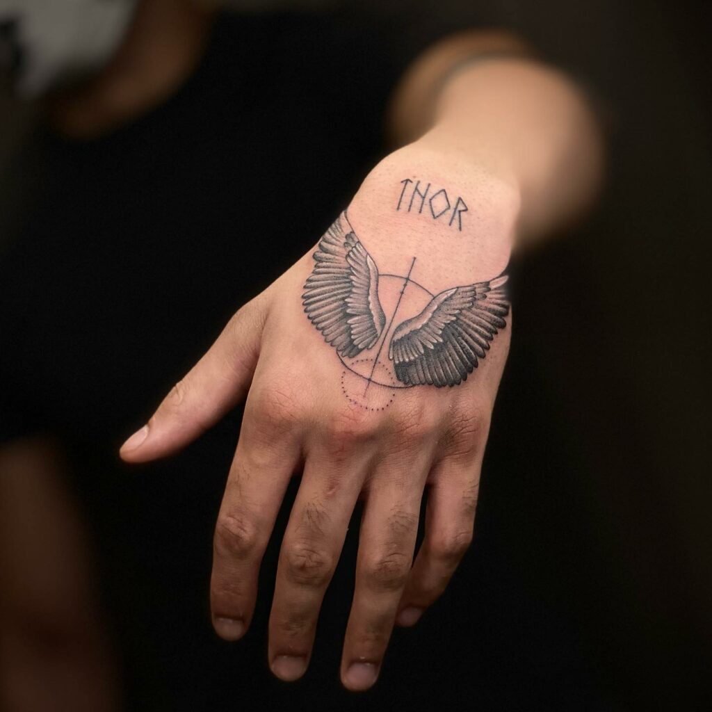 Creative Name Hand Tattoo With Wings Design