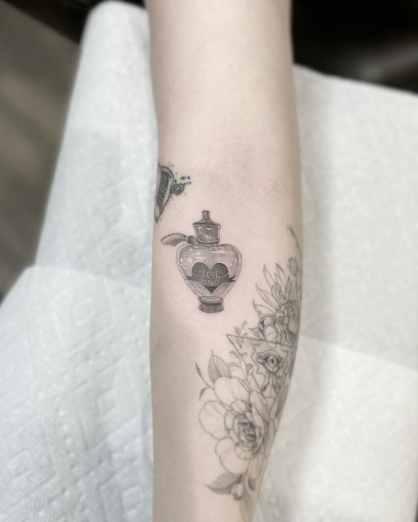 Dainty Tattoo Of Magical Love Potion