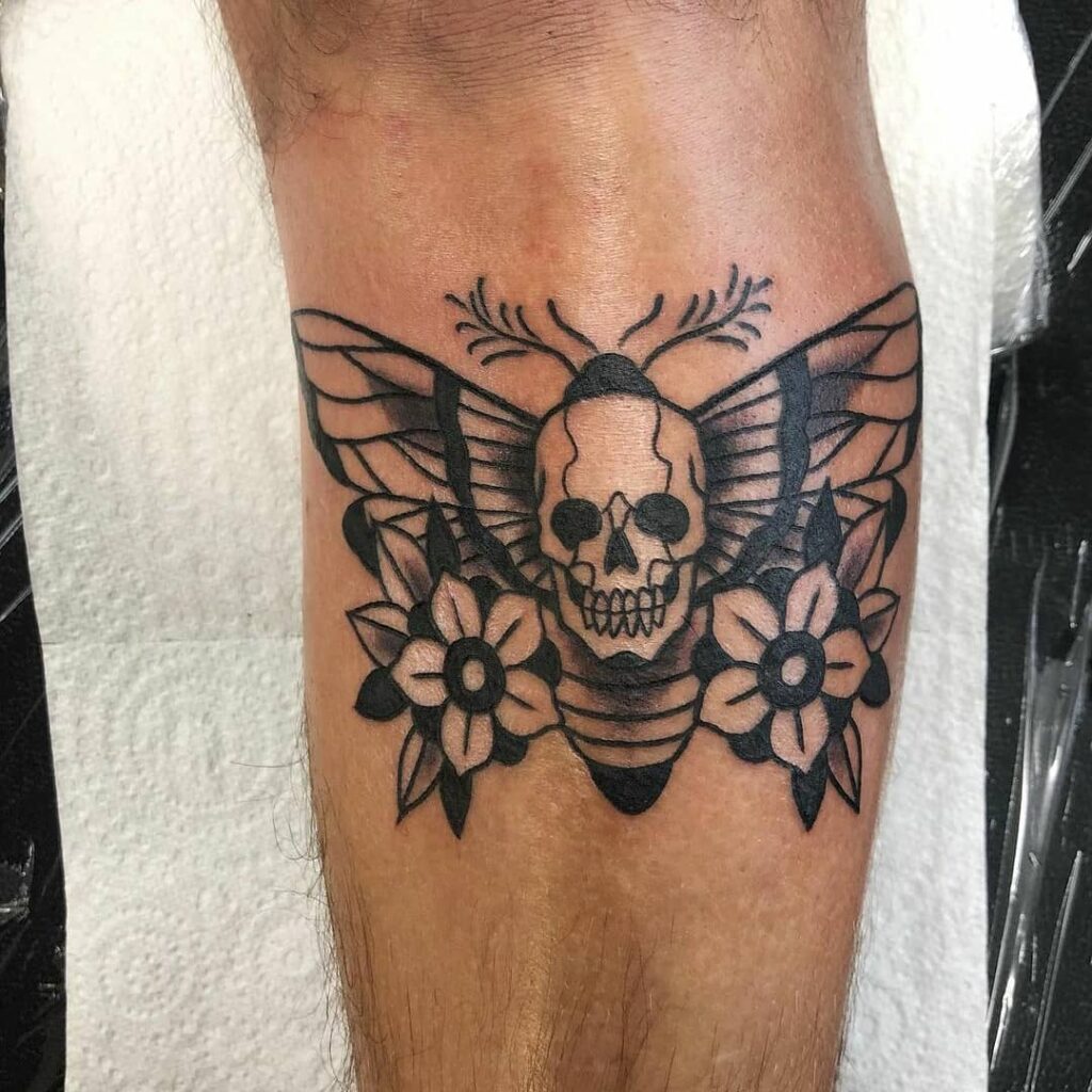 Death Moth With A Pair Of Flowers Tattoo