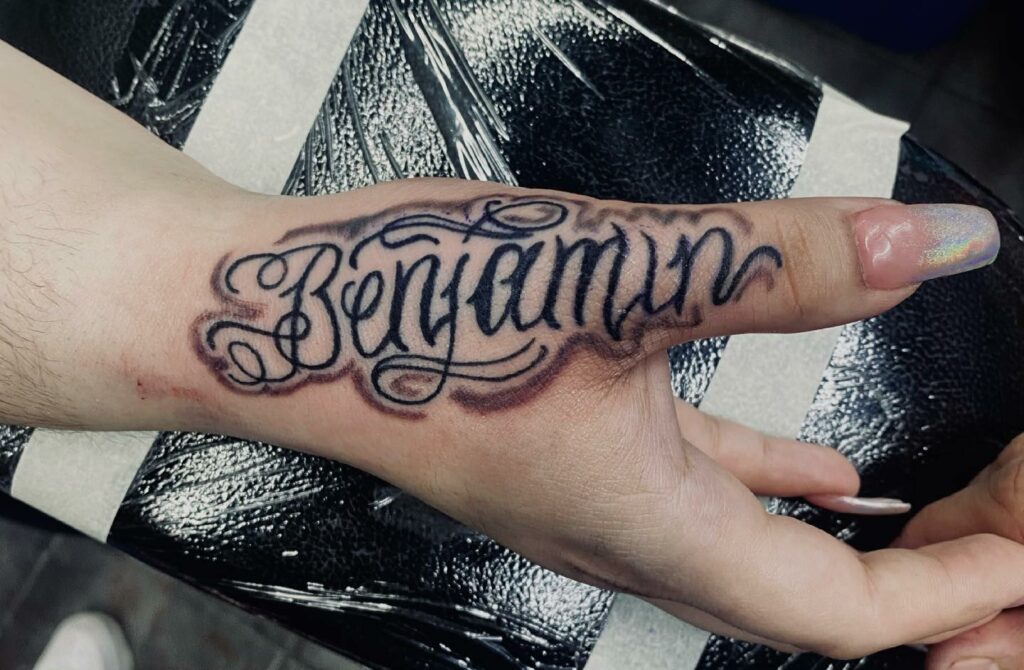 Dynamic Ink Name Hand Tattoo