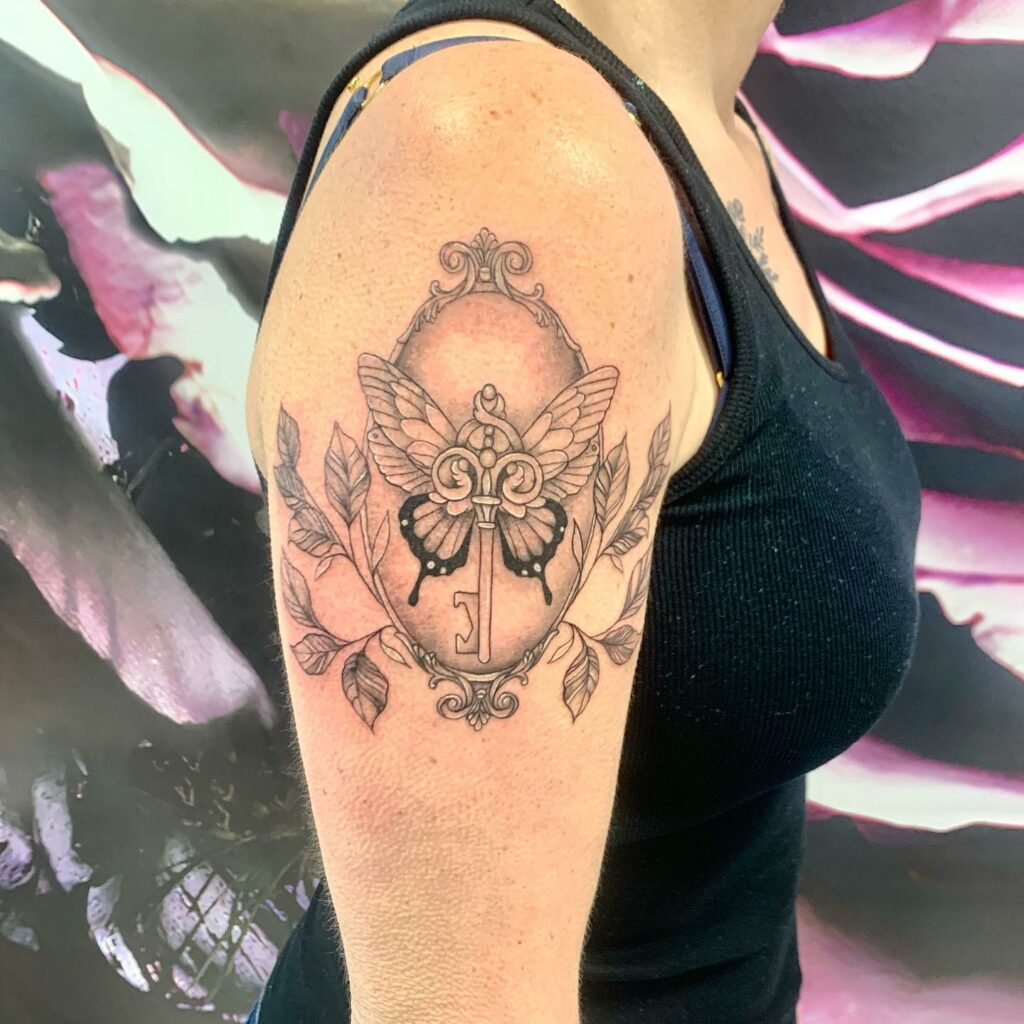 Elegant Wings and Leaves Key Tattoo