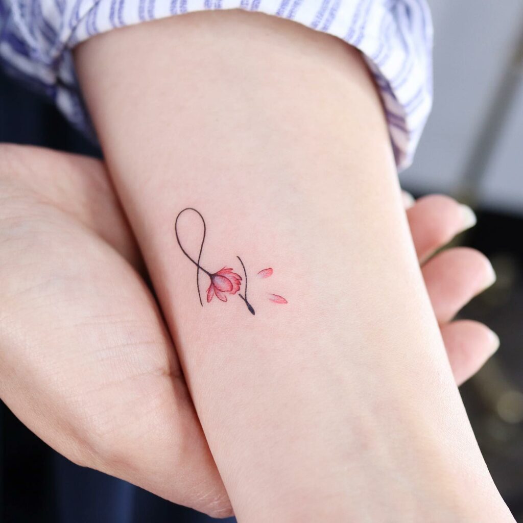Tiny letter j tattoo on the wrist
