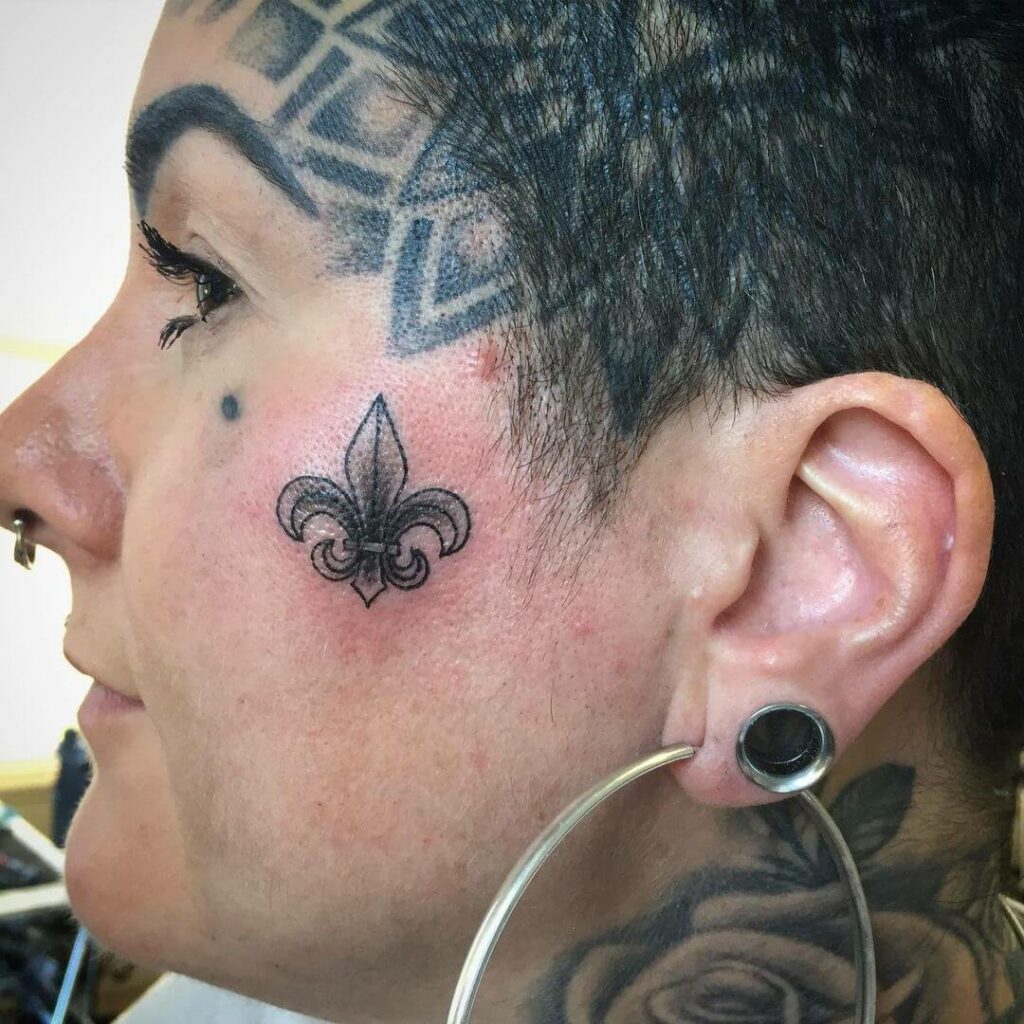 Fleur De Lis Face Tattoo