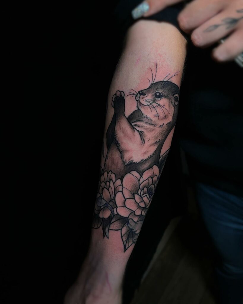 Forearm Otter Tattoo With Flowers