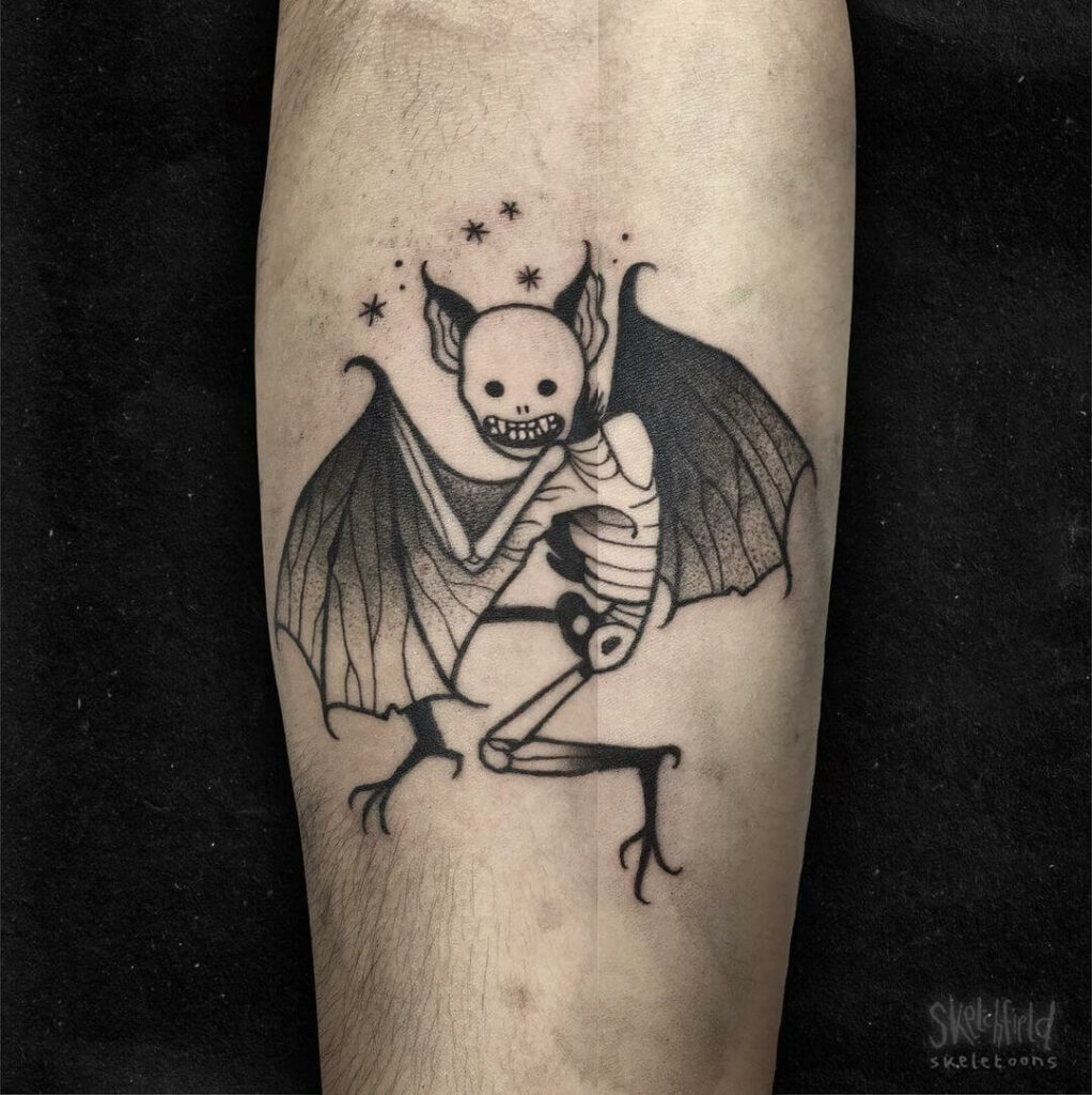 Bat face tattoo on the inner arm