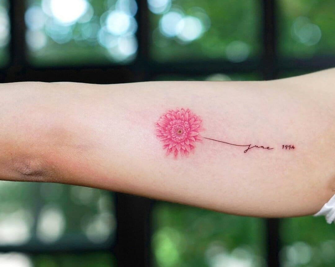 Sketch work daisy tattoo on the left inner forearm