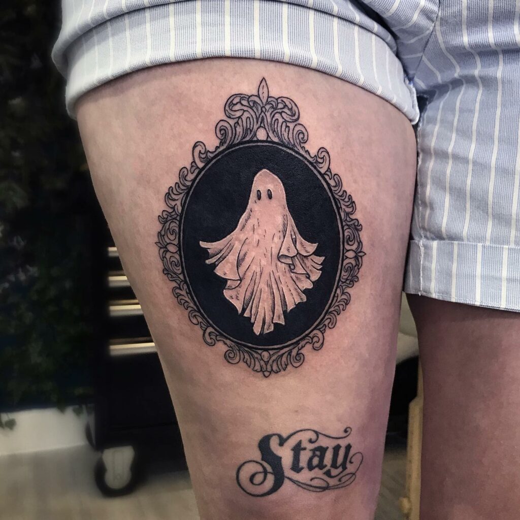 Minimalistic tiny ghost tattoo located on the wrist