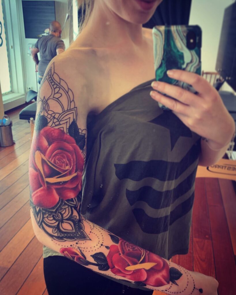 Sketchy rose tattoos on the left shoulder